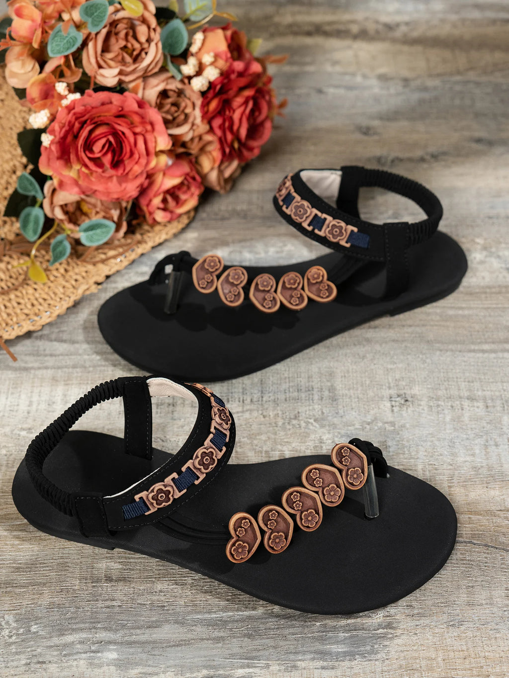 Fashionable flat sandals with a specially designed toe loop and toe separator, featuring heart decorations and a bohemian style