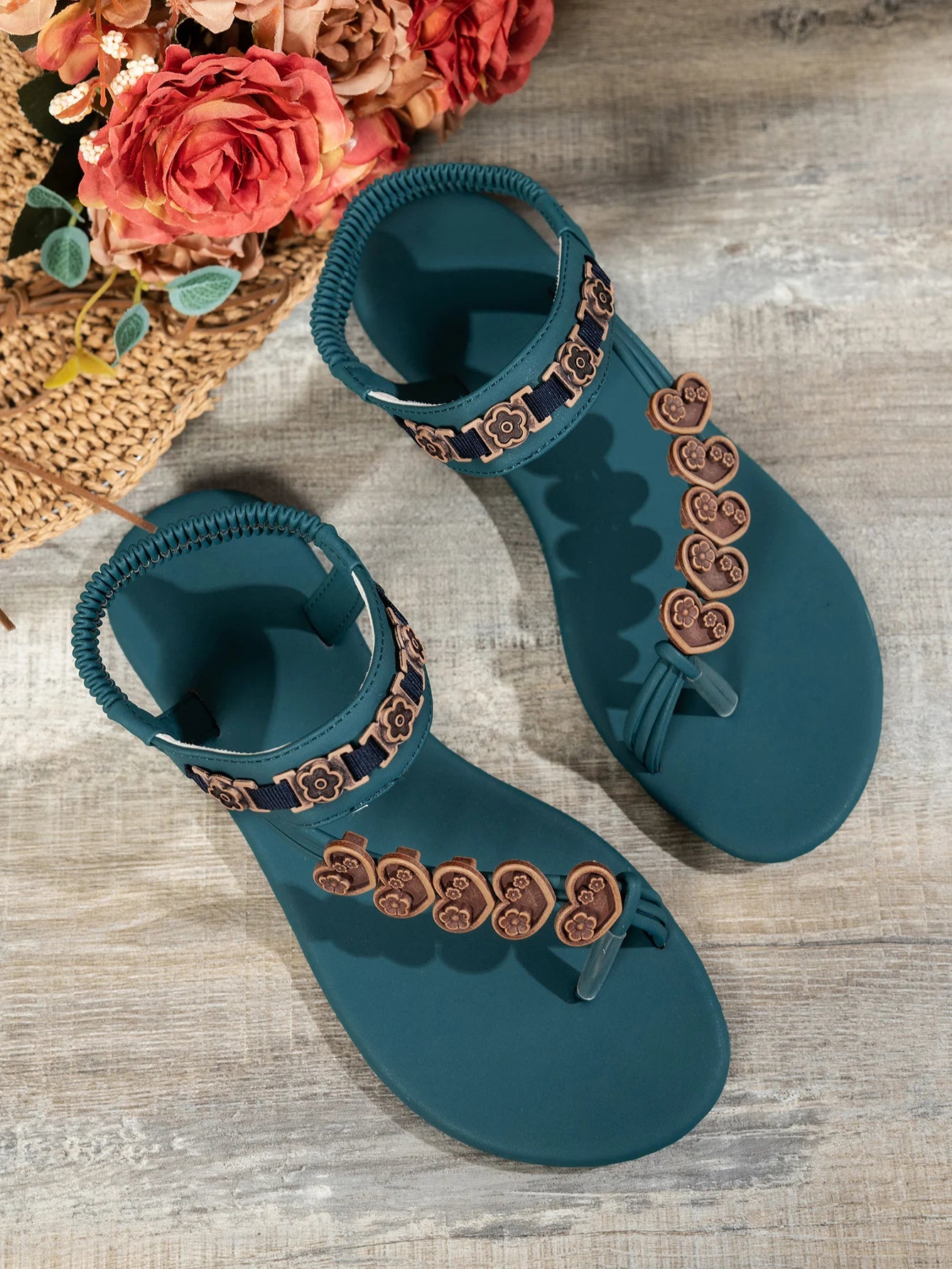 Fashionable flat sandals with a specially designed toe loop and toe separator, featuring heart decorations and a bohemian style