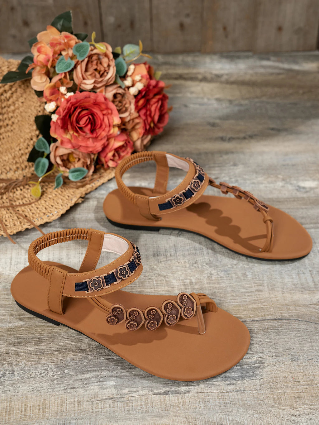 Fashionable flat sandals with a specially designed toe loop and toe separator, featuring heart decorations and a bohemian style