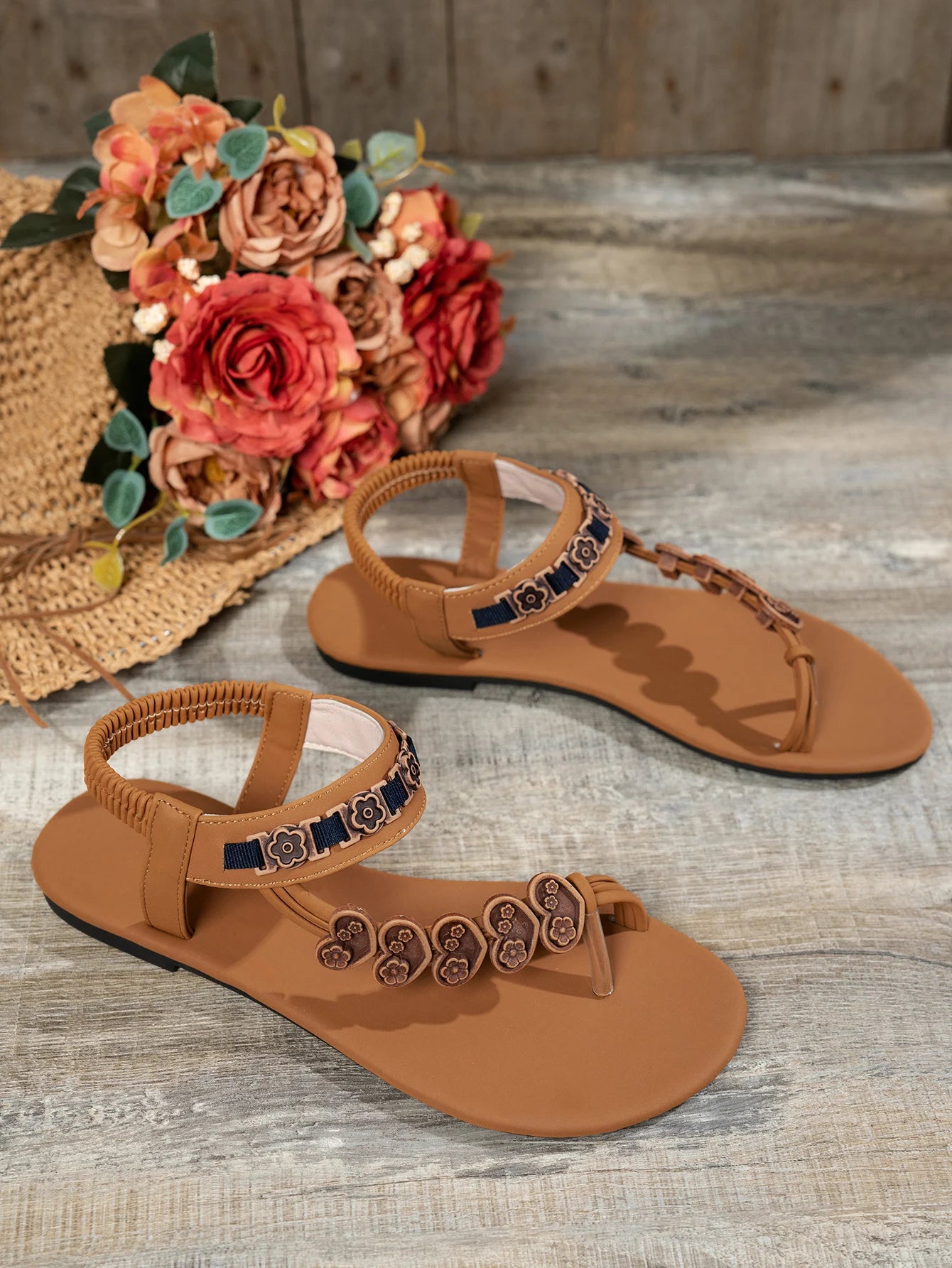 Fashionable flat sandals with a specially designed toe loop and toe separator, featuring heart decorations and a bohemian style