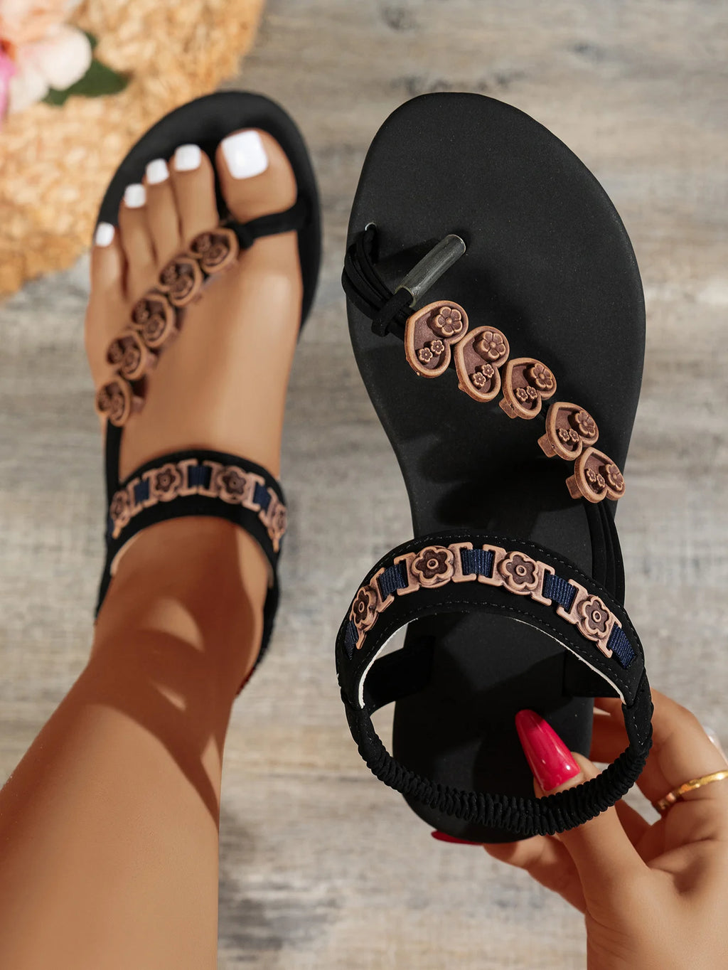 Fashionable flat sandals with a specially designed toe loop and toe separator, featuring heart decorations and a bohemian style